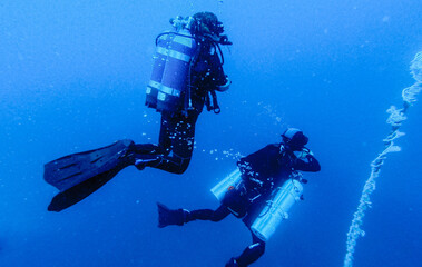 Scubadiving. Scuba divers diving at the shipwreck.
