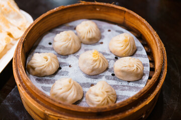 Steamed Xiao Long Bao (Soup Dumplings) in The Bamboo Basket. Served in Restaurant in Taipei, Taiwan.