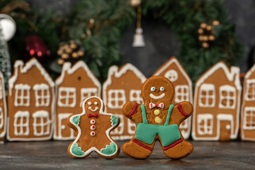 Various christmas gingerbread cookies on dark table with flour