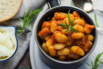 Stewed beans in tomato sauce with herbs and spices.  Top view.