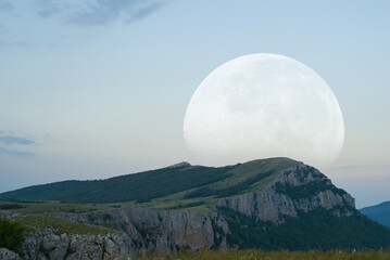 huge moon rising over the mount ridge at the twilight, fantasy stylized outdoor scene