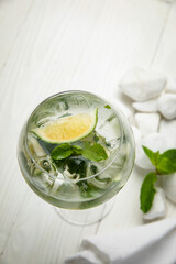 alcoholic cocktail with ice. On a wooden, white table
