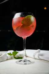 alcoholic cocktail with ice. On a wooden, white table
