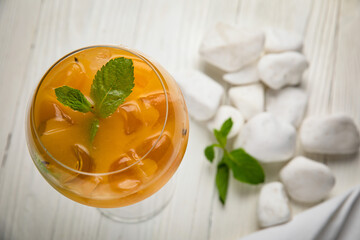 alcoholic cocktail with ice. On a wooden, white table
