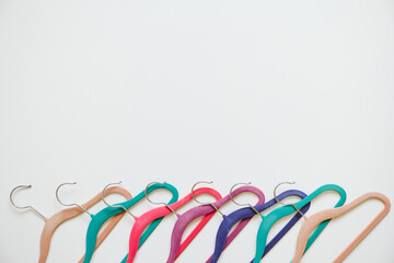 Sustainable responsible consumption concept. Many bright multi-colored velvet pop color hangers on...