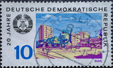 GERMANY, DDR - CIRCA 1969: a postage stamp from Germany, GDR showing cityscape of the city of Suhl with the GDR emblem on the occasion of the 20th anniversary