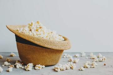 Salted popcorn in a straw hat