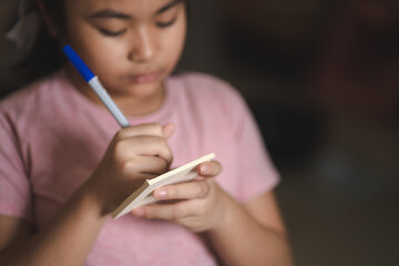 Obraz premium The girl is writing a book