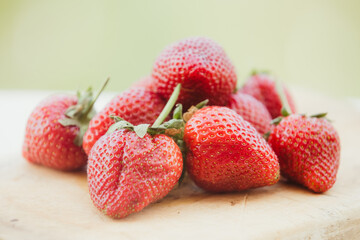 Organic ripe strawberries on wooden background