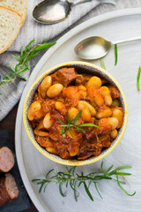 Stewed beans in tomato sauce with herbs and spices.  Top view.