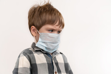 Serious little boy in a medical mask
