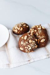 chocolate chip cookies with nuts and peanuts on a table with a tea napkin