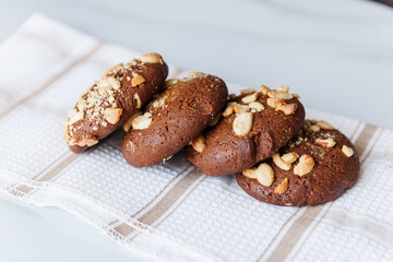 chocolate chip cookies with nuts and peanuts on a table with a tea napkin