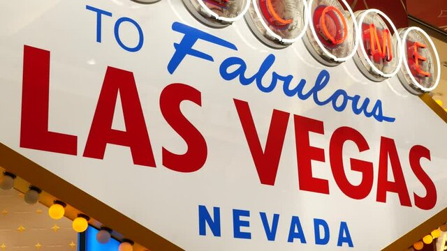 Welcome to fabulous Las Vegas retro neon sign in gambling tourist resort, USA. Iconic vintage glowing banner, symbol of casino, games of chance, money playing and hazard bets. Illuminated signboard.
