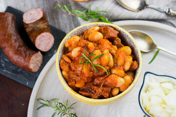 Stewed beans in tomato sauce with herbs and spices.  Top view.