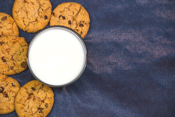 Cookies with milk on a blue background copy space