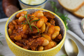 Stewed beans in tomato sauce with herbs and spices.  Top view.