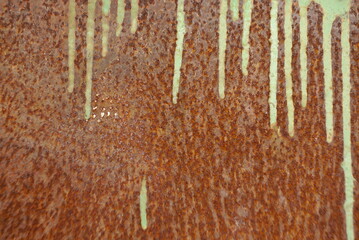 streaks of paint on a rusty metal surface