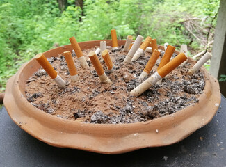 Used cigarettes in a sand tray. Cigarette butts.