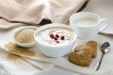 Sesame dry cookies in the form of heart, porridge of amaranth and yogurt, healthy breakfast.