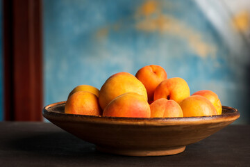 Ripe Apricot fruit isolated on a wooden table in a bowl