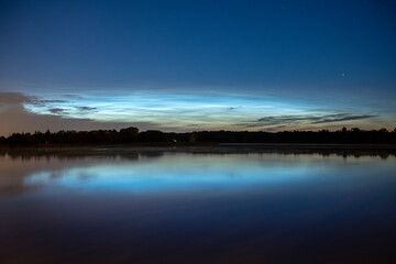Rare noctilucent clouds at summer night sky
