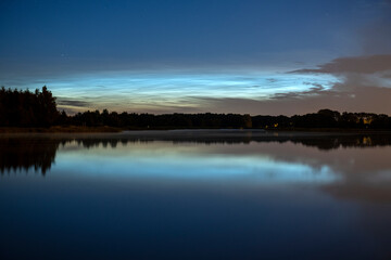 Rare noctilucent clouds at summer night sky