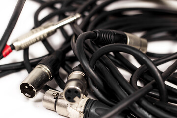 Fototapeta na wymiar Various black sound cables like Jack input and XLR close-up 