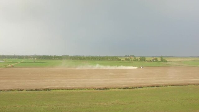 Droneshots of a tractor in the fields of Holland