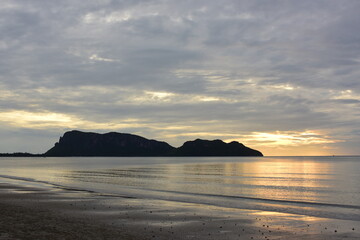 Early morning sea view. The sunrise view against the golden yellow sky