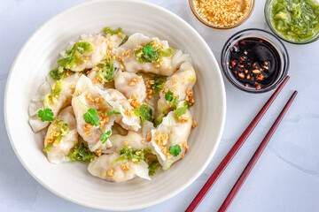 Shrimp Dumplings with Nam Jim Sauce in a White Bowl with Chopsticks Horizontal Directly Above Photo
