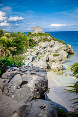 Fototapeta na wymiar Panoramic view of the mayan ruins of Tulum, Mexico. God of Winds Temple in a sunny day. Mayan ruins of Tulum, Quintana Roo, Mexico.