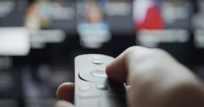 User browsing video streaming content with wireless remote control on a smart tv