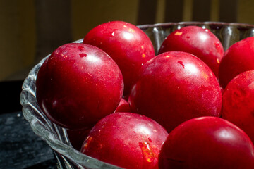 red plums with a black wooden background 