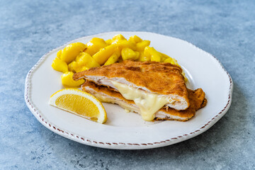 Cordon Bleu Chicken Schnitzel with Potato Salad. Half cut.