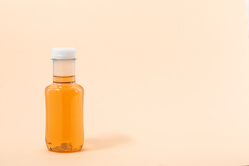 Bottle of ice tea drink, beige background