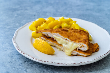 Cordon Bleu Chicken Schnitzel with Potato Salad. Half cut.