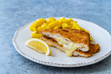 Cordon Bleu Chicken Schnitzel with Potato Salad. Half cut.