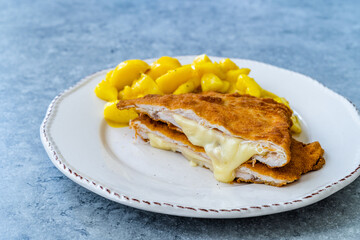 Cordon Bleu Chicken Schnitzel with Potato Salad. Half cut.