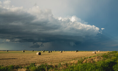 Bales of hay and storm clouds