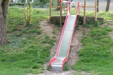 Corona virus quarantine lockdown prohibit playground slide. Closure by barrier tape. Covid-19...