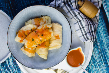 Golabki - traditional Polish food. Stuffed cabbage and tomato sauce garnished with fresh parsley.