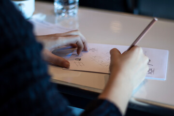 Female person taking notes during a meeting or in school