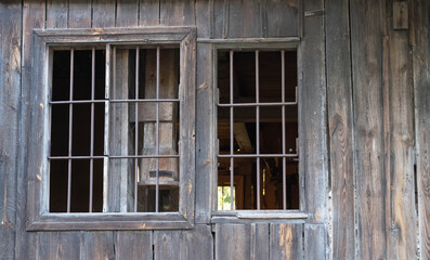 Fototapeta na wymiar old plank wall and two windows