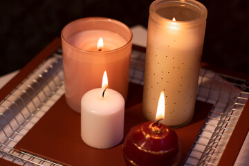 set of candles - pink and red - on a handmade metal tray. home interior and decor. High quality photo