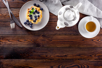 belgian waffles on dark wooden background top view mockup