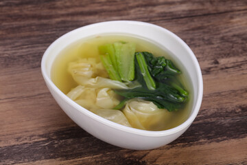 Asian traditional Wonton soup with herbs