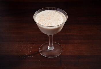 Brandy Alexander cocktail on a walnut bartop