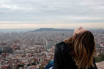 Fototapeta na wymiar happy girl enjoys the views of a viewpoint in the city of Barcelona