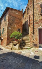 Naklejka premium Montepulciano, Tuscany, Italy - July 15 2020: Beautiful view of an alley of Montepulciano, a tuscan town between val d' Orcia e val di Chiana in Italy.